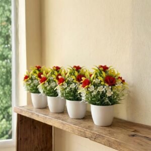 Artificial flower plant with red and white flowers and green leaves in a white decorative pot.