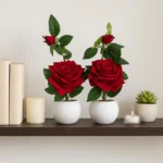 Decorative artificial rose plant for home décor with red roses in white plastic pot.