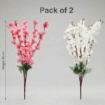 Artificial cherry blossom flowers in pink and white displayed in a clear glass vase for interior decoration