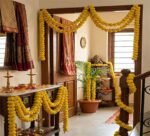 Traditional artificial marigold garland decoration with yellow flower strands used for festival and wedding décor