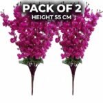 Artificial cherry blossom flowers in purple displayed in a clear glass vase for interior decoration