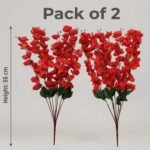 Artificial cherry blossom flowers in red and red displayed in a clear glass vase for interior decoration.